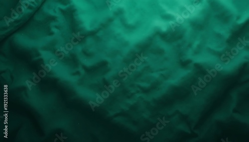 Dark emerald green silk fabric texture with soft wavy folds