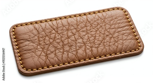Brown leather wallet with tree bark texture design lying flat on neutral background minimalist closeup