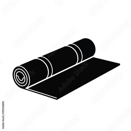 Modern black yoga mat rolled up on floor
