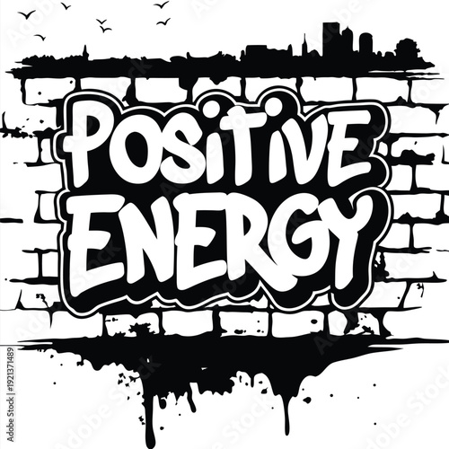 The phrase Positive Energy appears graffiti style on a distressed black and white brick wall