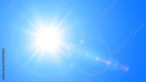 Sun with lens flare and blue sky, spring and summer background, concept of beautiful clear weather.
