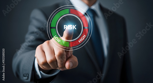 Wallpaper Mural A businessman's finger touches a glowing circular risk meter showing a spectrum from low to high. Torontodigital.ca