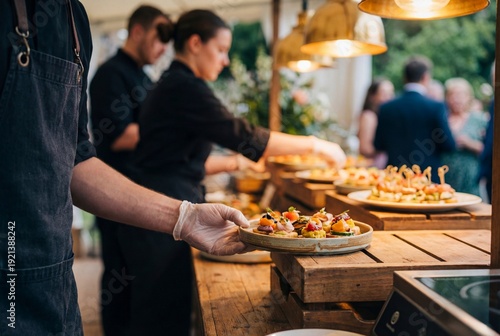 Catering team serving gourmet appetizers at elegant outdoor event