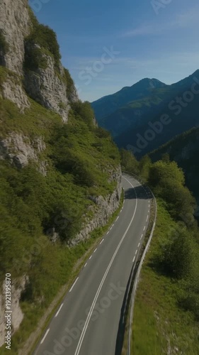 Winding Mountain Road Through Green Landscape.