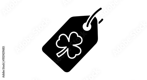 Black tag with white clover icon hanging from string viewed from above in simple composition
