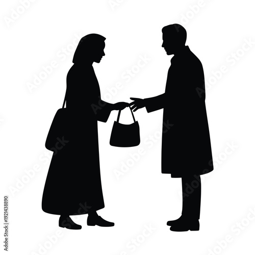 Silhouette of a couple exchanging an item possibly a gift or bag