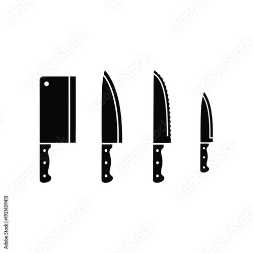 Collection of kitchen knives and cutting board on a white background viewed from the side