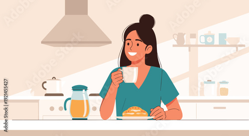 Happy woman enjoying a morning cup of coffee and a pastry while sitting at the counter in her modern bright kitchen.