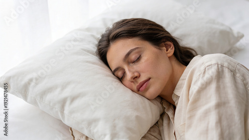 Young woman sleeping peacefully on a pillow in a bright room  