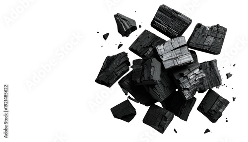Pile of dark, broken, charred wood pieces against a stark black void
