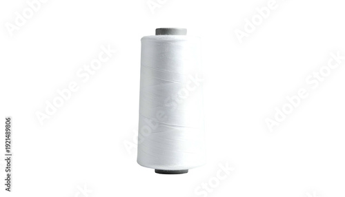 White thread spool, vertically oriented, against a black background