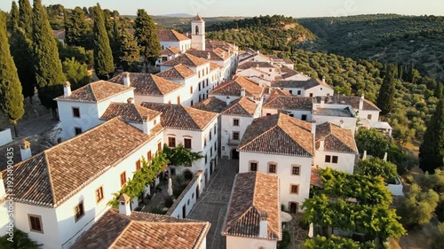 White village houses with cypress trees and olive groves