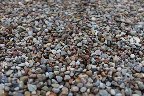 Pebbles or decorative gravel, naturally rounded stones that are often used for gardening and landscaping, the surface is smooth and the stones are mixed in different colors