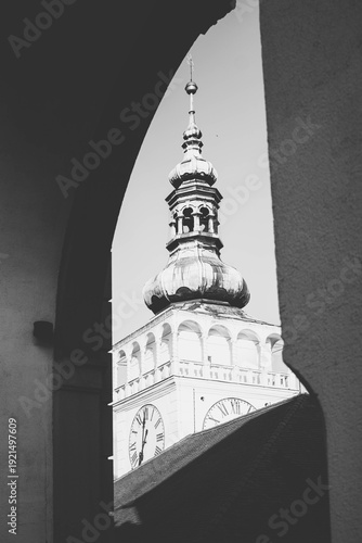 Black and white view through an archway of a decorated Baroque facade