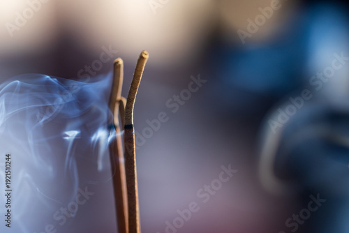 Stone lions in temple incense burners and wispy incense smoke