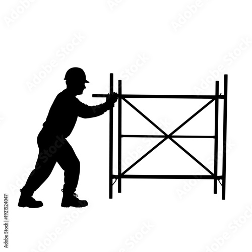 Silhouette of a Construction Worker Pushing a Scaffolding Structure.