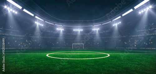 Football or soccer field at a sports stadium in foggy weather with shining floodlights and fans ready for an upcoming nighttime sports event.