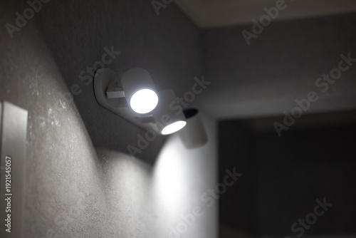 Modern LED Wall Sconce Lamp Turned On Illuminating Room with Bright White Light