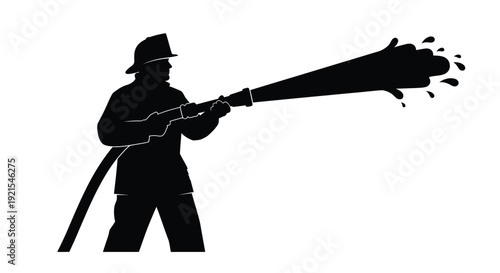 Silhouette of a firefighter directing a powerful stream of water