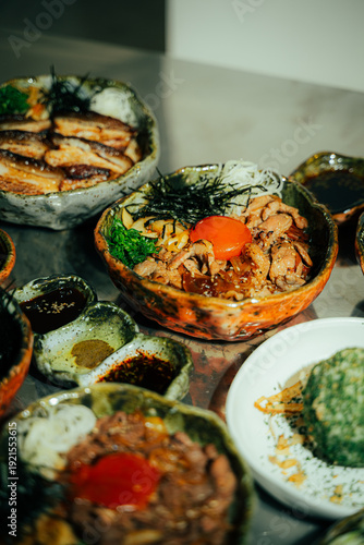 Close-up of a traditional Japanese beef rice bowl (donburi) topped with fresh raw egg yolk, shredded nori seaweed, green onions, and caramelized onions. Served in a rustic ceramic bowl with grilled po