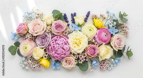 Horizontal flat lay of a colorful spring flower arrangement with pink roses peonies ranunculus and lavender on a clean white background. Fresh botanical composition for greeting cards and branding.