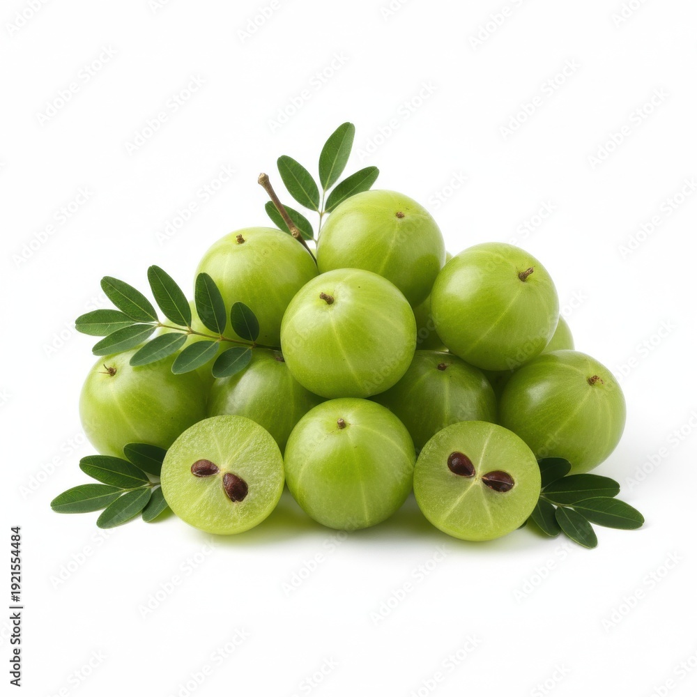 Obraz premium Heap of ripe green indian gooseberries amla fruits with fresh leaves, whole and cut halves showing seeds