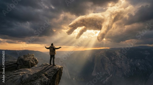 Small man sees God's hand in clouds seeking salvation from death concept. A person stands on a cliff, embracing dramatic cloud formations.