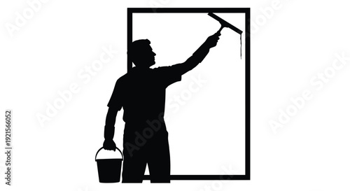 Silhouette of a window washer cleaning a tall glass surface