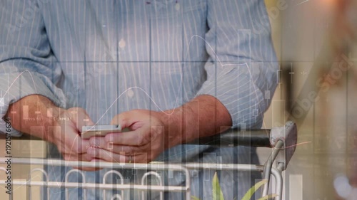 A senior man is using a phone at a grocery store