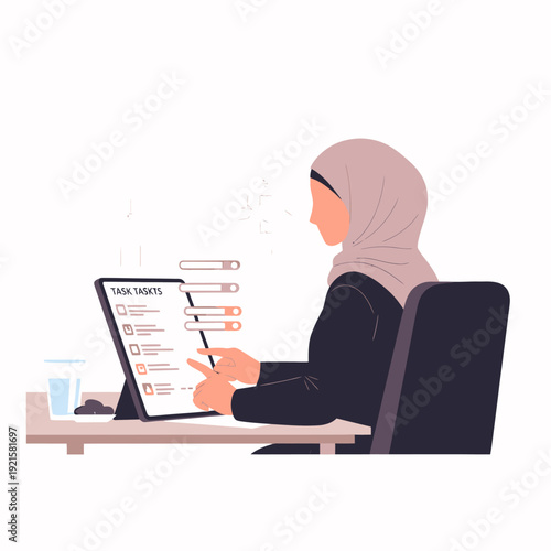 woman in hijab working on laptop.