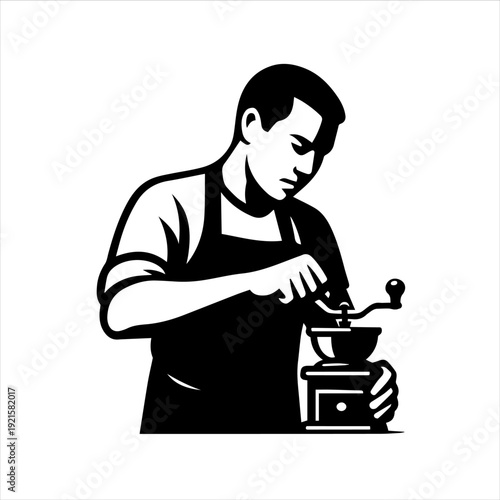 A man in an apron grinding coffee beans with a manual grinder on a plain white background
