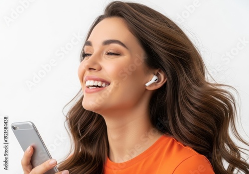 A woman wearing wireless earbuds and holding a smartphone