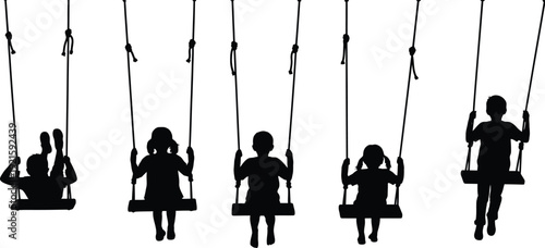 Silhouettes of children playing on swings in a park