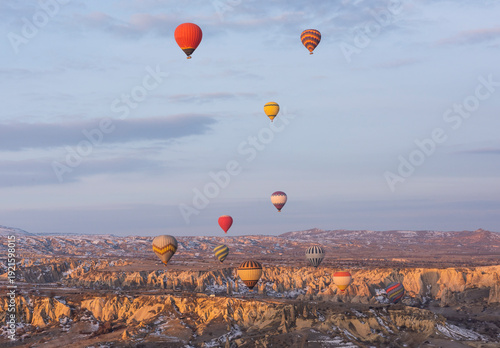 Wallpaper Mural Panoramic landscape view across Cappadocia region valley with fairy chimneys and hot air balloons flying in sky Torontodigital.ca