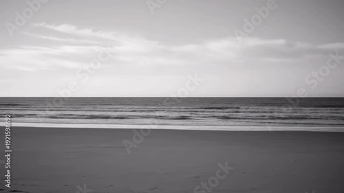 Desolate Horizon Capturing the vast, empty expanse where the ocean meets the sky in a monochrome palette.