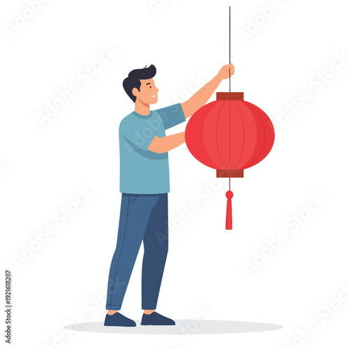 Man hanging a large red lantern in a festive cultural celebration scene from a sideways viewpoint