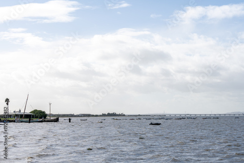 Wide Tagus estuary view with fishing boats and shoreline