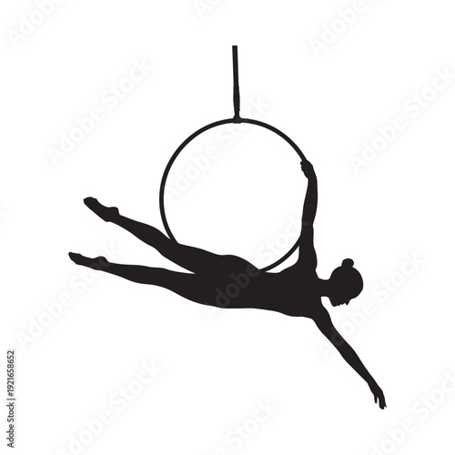Silhouette of an aerialist performing within a large metal hoop