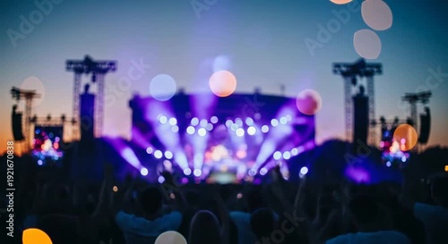 Energetic crowd silhouette at outdoor music festival with vibrant stage lights, bokeh
