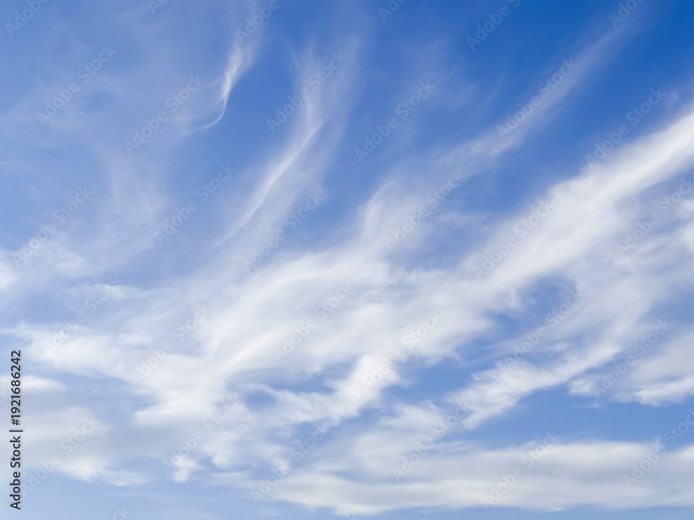 Fototapeta premium Dramatic blue sky with wispy white cirrus clouds creating natural patterns in atmosphere