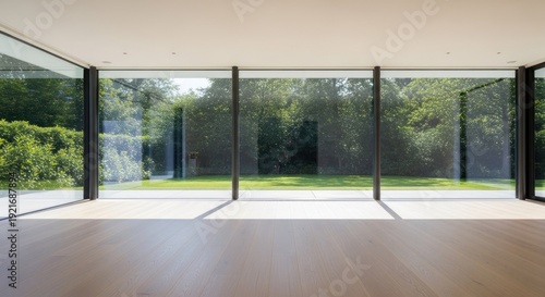 Modern interior view large windows framing lush green landscape