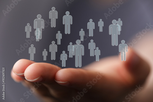 Hand holding human avatars,...