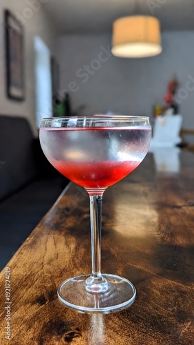 Elegant Red Cocktail in Frosted Coupe Glass on Wooden Table