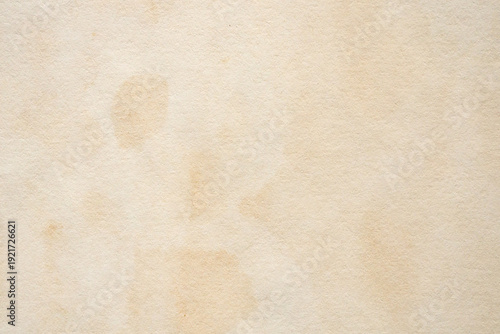 Old vintage paper texture background with aged stains and antique yellowed parchment effect