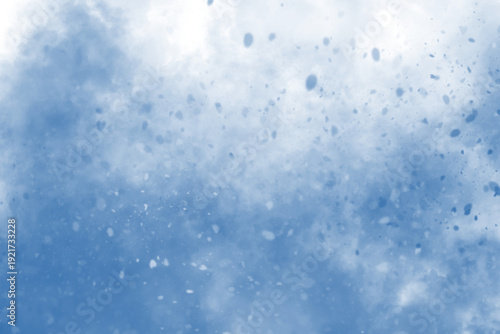 Bright blue sky with scattered white clouds seen from below.