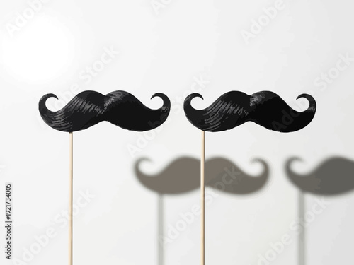 Two black cardboard mustaches on sticks with shadows