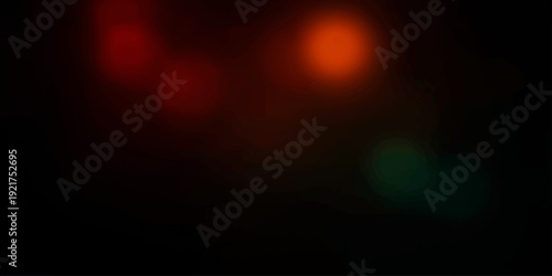 An abstract colorful background featuring red bokeh and glowing orange fire light creates a bright motion texture with energy and shine against a dark night sky