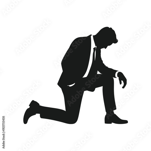 Silhouette of a kneeling businessman in a suit conveying submission or defeat