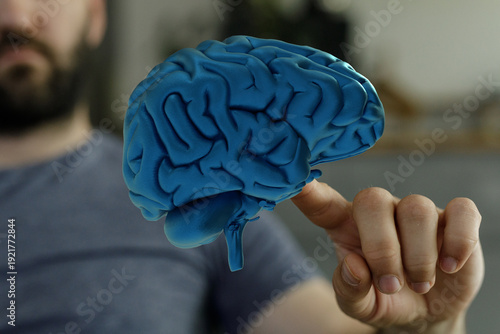 A man points to a blue brai...