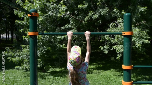 Wallpaper Mural Little girl pulls up on horizontal bar Torontodigital.ca